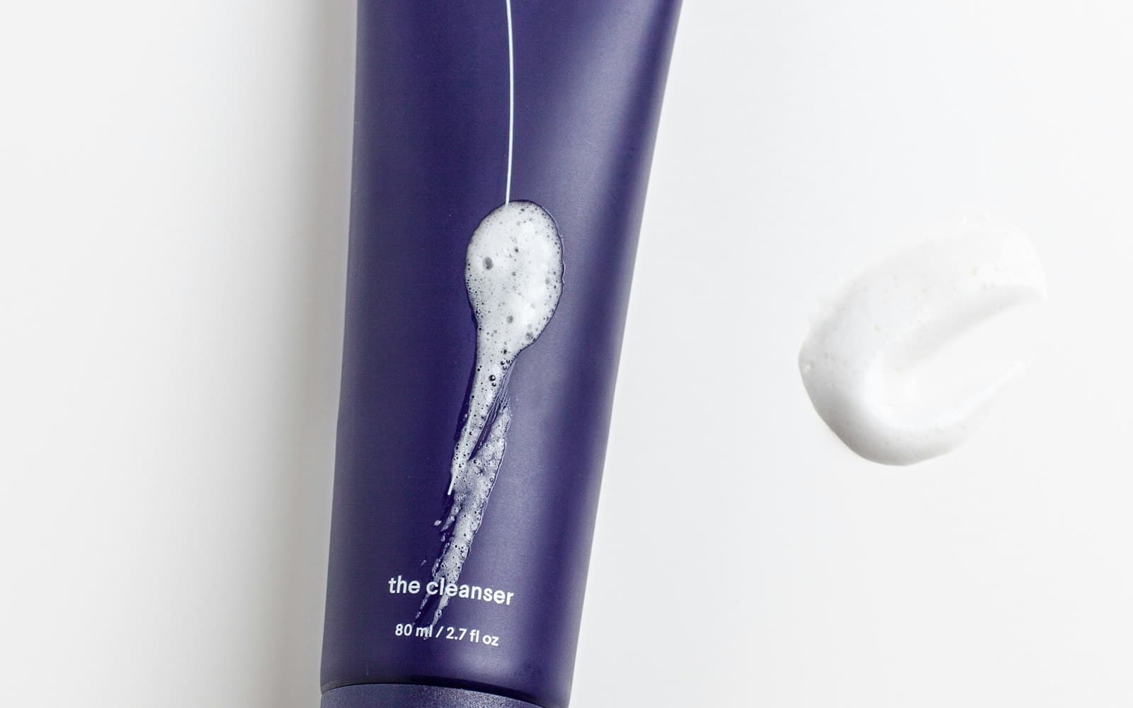 Minimal flat lay of travel-sized skincare products